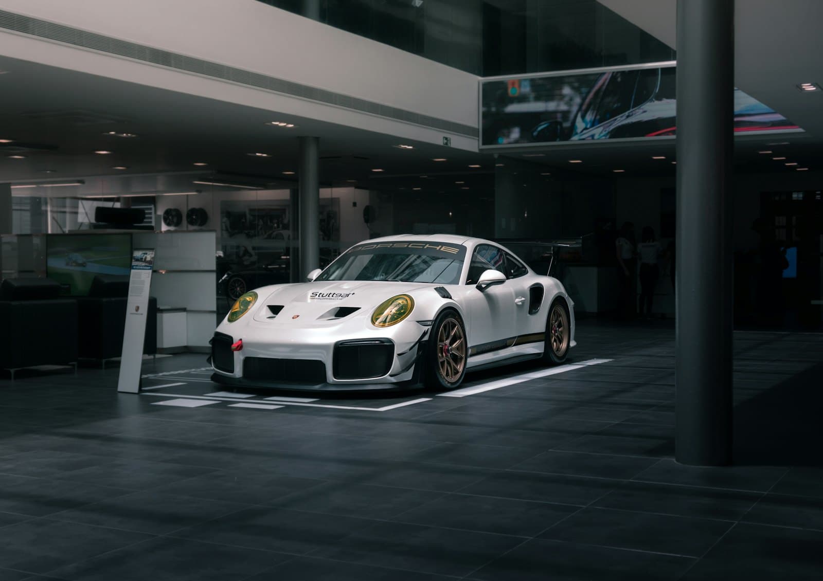 Performance coupe displayed inside a modern dealership showroom