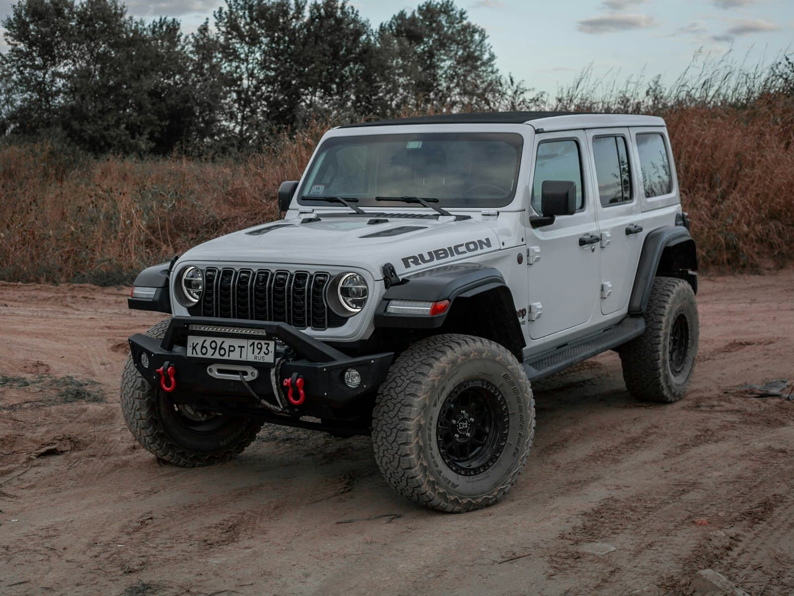 2024 Jeep Wrangler Unlimited Rubicon in Bright White on a dirt trail